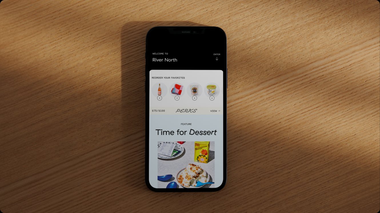 The Foxtrot app on a phone resting on a wooden table.