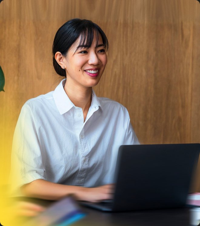 A Gradial teammate smiling at a laptop.