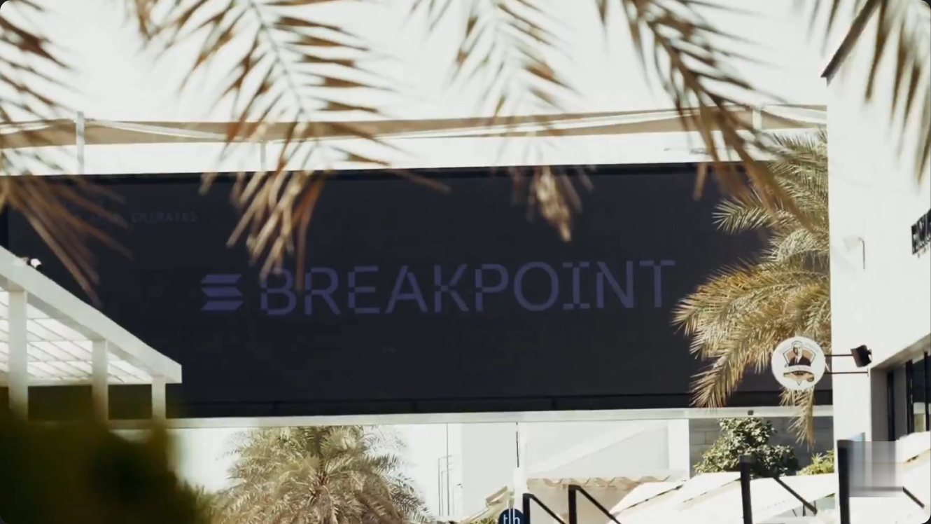 The Breakpoint banner seen through palm fronds.